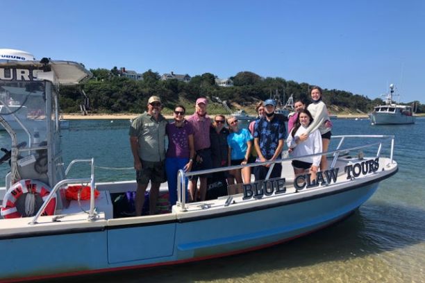 a group of people in a small boat in a body of water