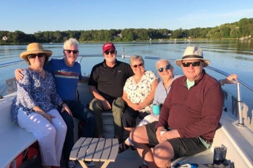 a group of people sitting on a boat